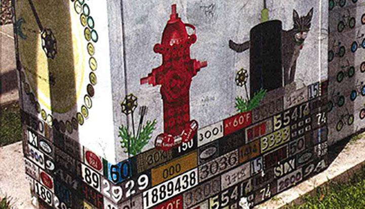 Utility box mural showing a cat with a fire hydrant and stop light