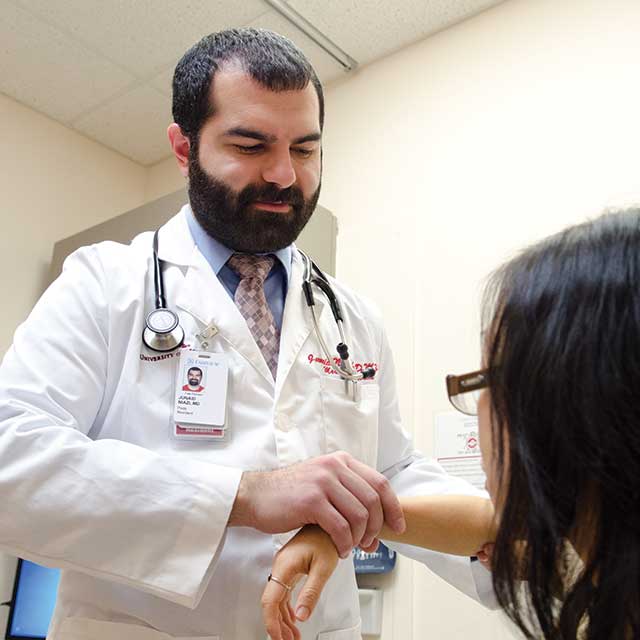 Doctor checking a patient's heart rate.