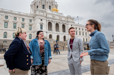 Students chatting outside of the capitol building in St. Paul